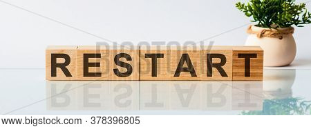 Wooden Blocks With The Text: Restart. The Text Is Written In Black Letters And Is Reflected In The M