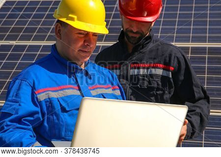 Green Energy, Two Tehnicians With A Laptop And Solar Panels