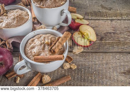 Quick Autumn Dessert Idea. Autumn Apple Pie Mugcake With Red Apples, Cinnamon, Spices, Rustic Wooden