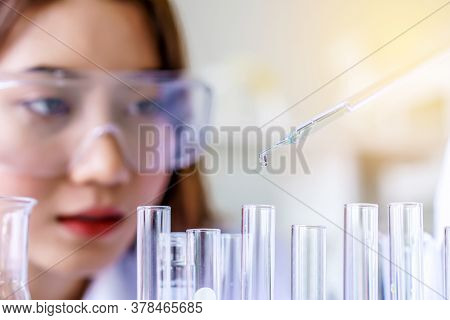 Doctor And Microbiologist With Vacuum Tubes For Samples With Covid 19 Infection Atypical Pneumonia V