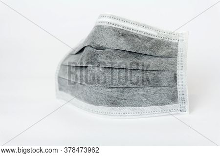 Used Black Medical Face Mask On White Background.coronavirus,covid-19,protec The Virus Concept