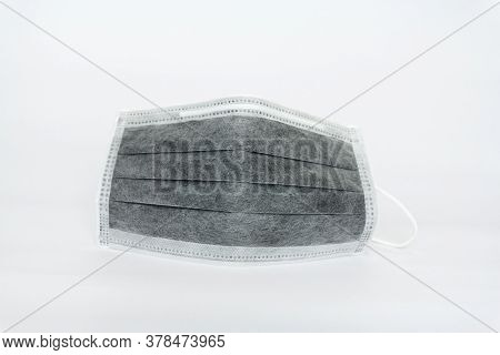 Used Black Medical Face Mask On White Background.coronavirus,covid-19,protec The Virus Concept
