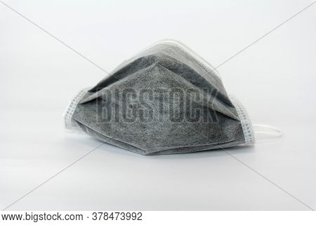 Used Black Medical Face Mask On White Background.coronavirus,covid-19,protec The Virus Concept