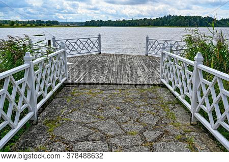 Wooden Jetty With White Fence In Sweden