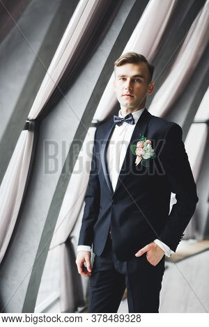 Happy Handsome Smiling Groom Posing With Boutonniere