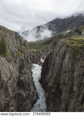 View From Footbridge Over The Wild Fernaubach Mountain Stream In Tyrol, Austria Close To Mittelstati