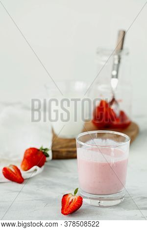 Organic Probiotic Milk Kefir Drink Or Yogurt With Strawberry In Glass On The White Grey Background. 
