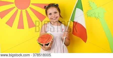 Little Girl On A Bright Background With The Italian Flag Holding A Fruit Basket In Her Hands. The Co