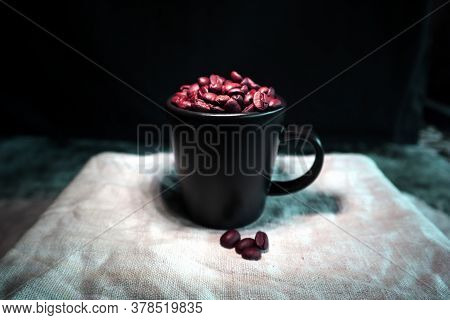 Black Ceramic Coffee Cup With Coffee Beans