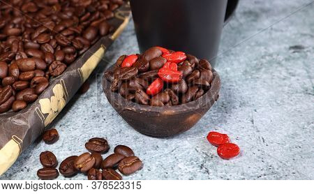 A Clay Pot With Coffee Beans On A Concrete Board