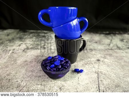 Ceramic Espresso Cups And A Small Clay Pot With Coffee Beans