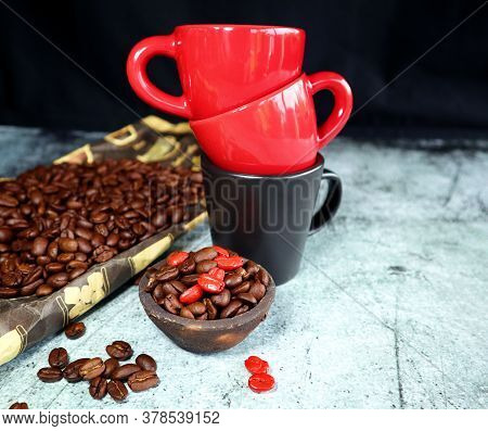 Coffee Cups And Coffee Beans On A Concrete Board
