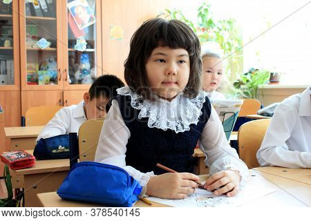 Moscow, Russia - September 1, 2017: Schoolgirls Sitting At The Desk In Class At School, Traditional 
