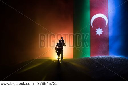 Azeri Army Concept. Silhouette Of Armed Soldiers Against Azerbaijani Flag. Creative Artwork Decorati