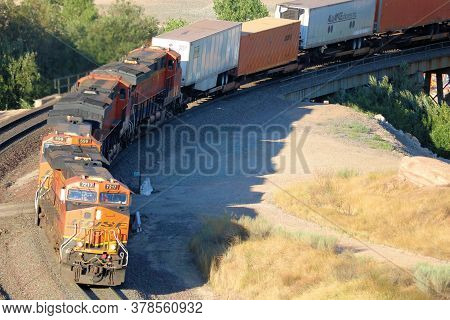 July 27, 2020 In Cajon, Ca:  Several Locomotives Hauling Rail Cars Up A Mountain Taken In The Cajon 