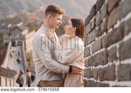 Beautiful Young Couple Hugging At The Great Wall Of China