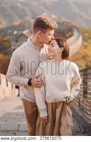 Beautiful Young Couple Hugging At The Great Wall Of China