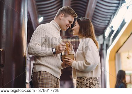 Newlywed Couple Eating Noodles With Chopsticks In Shanghai Outside A Food Market