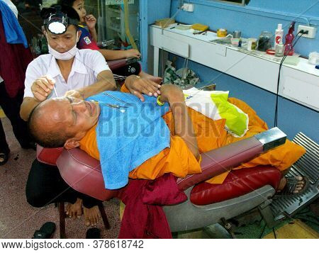 Bangkok, Thailand, January 11, 2016: A Buddhist Monk Undergoes Ear Cleaning At A Barber Shop In Bang