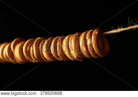 Traditional Russian Bagels On A Rope On Black Background