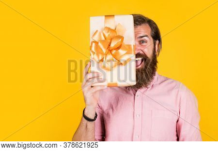 Surprised Male Open Cardboard Box With Something Exciting Inside. Mature Man Looking Casual In Surpr