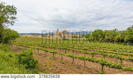 View Over Vineyard To Monastery Of Poblet In Spain In Summer
