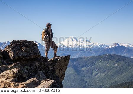 Adventurous Person Hiking In The Canadian Mountains During A Sunny Summer Morning. Taken On The Trai