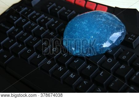 Blue Soft Gel Cleaning Dust On Keyboard. Concept Cleaning Your Computers Keyboard.