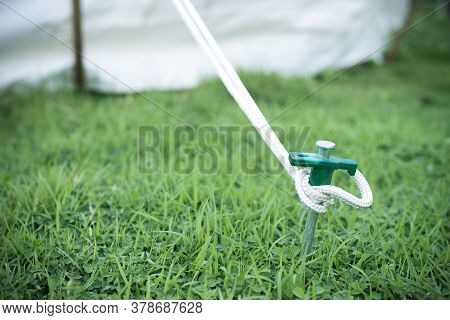 Close Up Of Tent Peg Anchor On The Ground Tent, Hook Of Tent, Camping,nature Tourism Concept