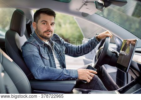 Test Driving Of New Generation Electro Vehicle With Self Driving System. Handsome Bearded Caucasian 