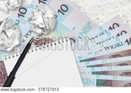 10 Polish Zloty Bills And Balls Of Crumpled Paper With Blank Notepad. Bad Ideas Or Less Of Inspirati