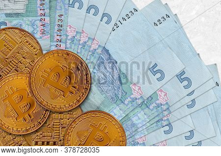 5 Ukrainian Hryvnias Bills And Golden Bitcoins. Cryptocurrency Investment Concept. Crypto Mining Or 