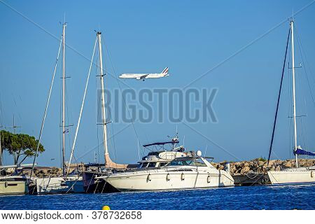 Cagnes- Sur-mer, France 24.07.2020. Flying Plane Over The Sea With Yachts. High Quality Photo