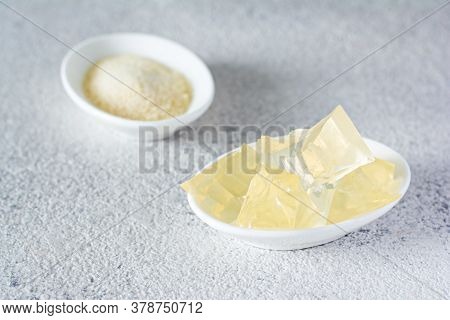 Gelatin, Agar-agar, Gelatinous Mass (cubes In The Form Of Crystals) On A Gray Background. Gelling Ag