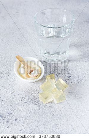 Gelatin, Agar-agar, Gelatinous Mass (cubes In The Form Of Crystals) On A Gray Background. Gelling Ag