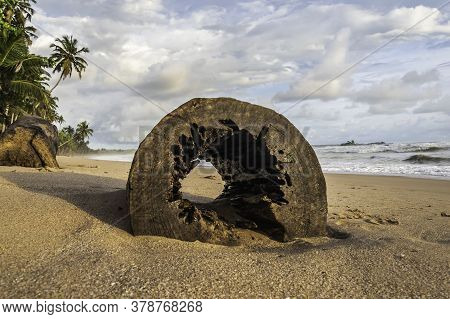Africa's Gold Coast With A Hollow Log On The Beach During Sunset In Axim Ghana West Africa