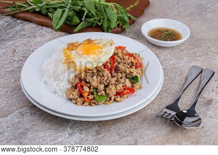 rice topped with stir-fried mince pork and basil with fried egg , Thai famous Street food