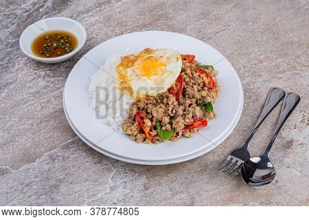 rice topped with stir-fried mince pork and basil with fried egg , Thai famous Street food