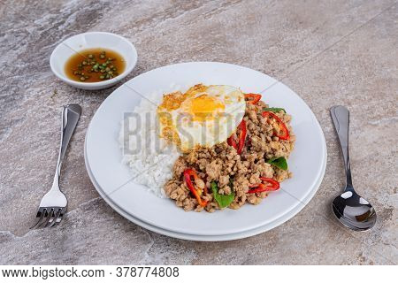 rice topped with stir-fried mince pork and basil with fried egg , Thai famous Street food