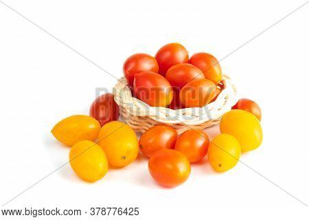 Cherry Tomatoes In A Basket. (solanum Lycopersicum L. Var. Cerasiforme). Isolated On White Backgroun