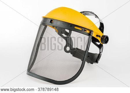 Yellow Construction Mask-grid On A Wooden Table On A White Background