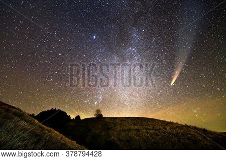 Night Landscape Of Mountains With Stars Covered Sky And Neowise Comet With Light Tail.