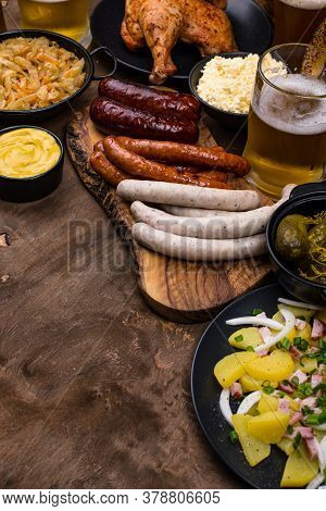Oktoberfest Dishes: Beer, Pretzel, Sausage, Stewed Cabbage, Potato Salad Half Of Chicken And Ribs