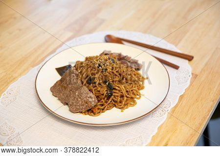 Korean Traditional Black Bean Noodle. Jajangmyeon With Sliced Beef. Ramyeon With Wooden Spoon And Ch