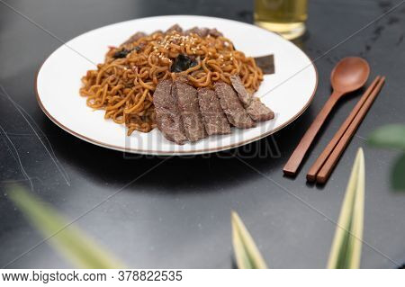 Korean Black Bean Sauce, Jajjangmyeon Noodles With Sliced Beef On Top With Wooden Spoon And Chopstic
