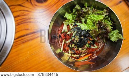 Korean Traditional Food, Spicy Cold Soba Noodles, Bibim Guksu, On A Stainless Steel Bowl