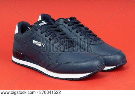 Varna , Bulgaria - Octomber 12, 2019 Puma Runner V2 Full Leather Sport Shoes On Red Background. Puma