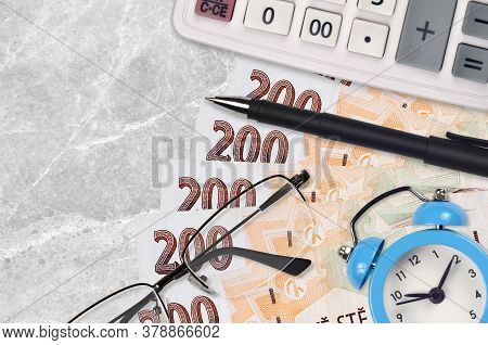200 Czech Korun Bills And Calculator With Glasses And Pen. Business Loan Or Tax Payment Season Conce