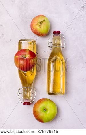 Bottles Of Apple Vinegar And Ripe Apples On Kitchen Towel Light Gray Background Vertical Apple Cider