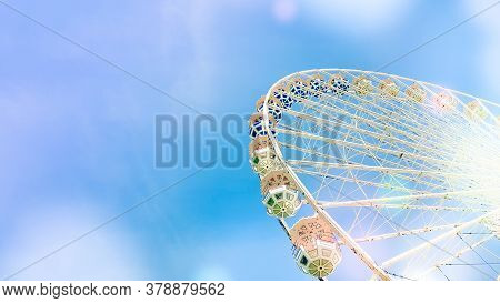 Ferris Wheel On The Background Of Blue Sky With Round Colorful Bright Circles